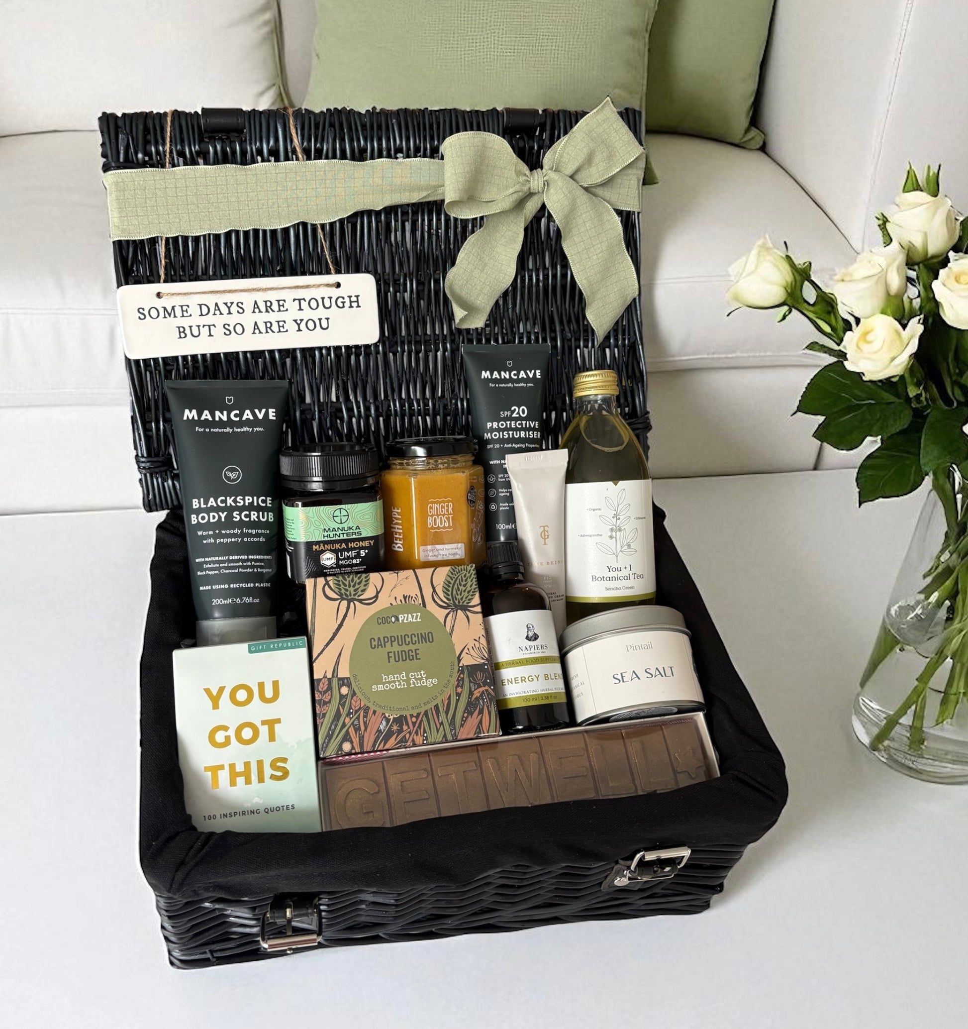 Luxury get well soon hamper for him with skincare, honey, tea, fudge, candle, tonic, and uplifting book – ideal recovery gift.