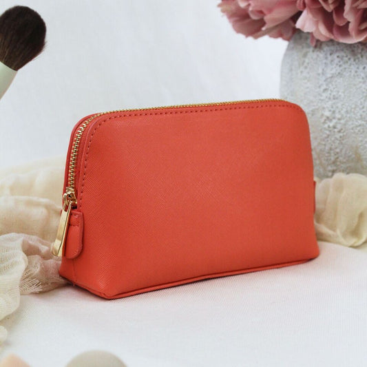Medium Saffiano fine grain faux leather cosmetic bag in coral color.