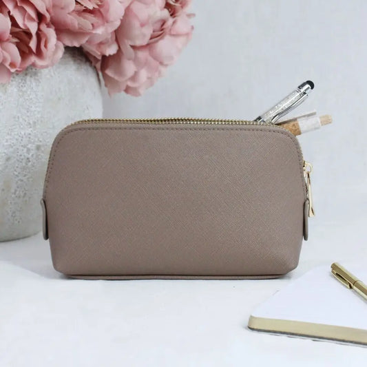 Medium taupe saffiano fine PU leather zipped cosmetic bag on tabletop.