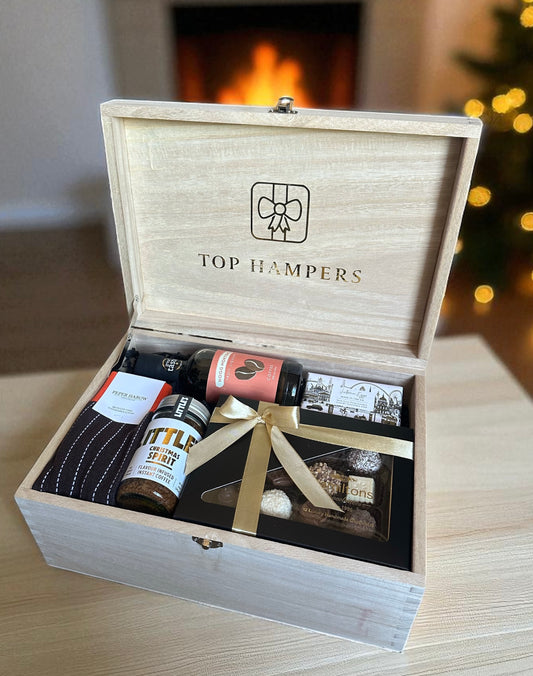 Men’s Christmas gift box with luxury chocolates, smooth coffee liqueur, English soap, Peper Harrow socks, and festive Christmas coffee in a wooden box.