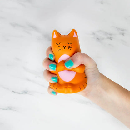 Meditating cat stress toy in a peaceful pose, designed to squeeze for stress relief.