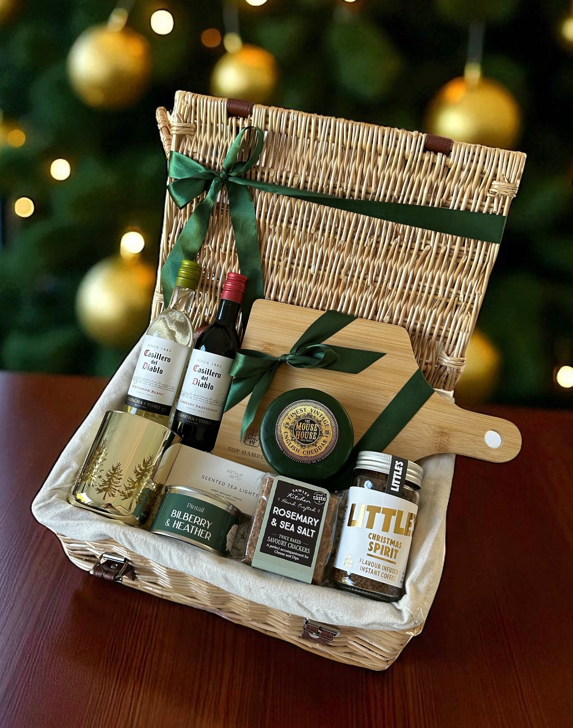 Merry Little Cheeseboard featuring Casillero del Diablo wine miniatures, vintage cheddar truckle, crackers, coffee, wooden board, candles & tea lights.