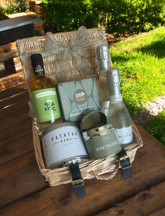 Elderflower spritz hamper with Prosecco, crisps, truffles & a honeysuckle-scented candle.
