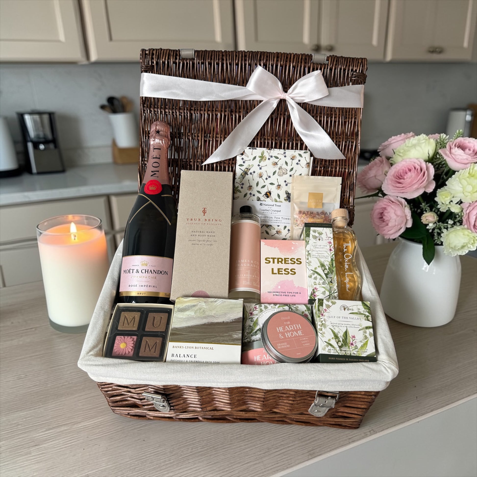 Mum’s luxury gift hamper with sparkling wine, skincare, candles, chocolates, bath salts and pamper items.