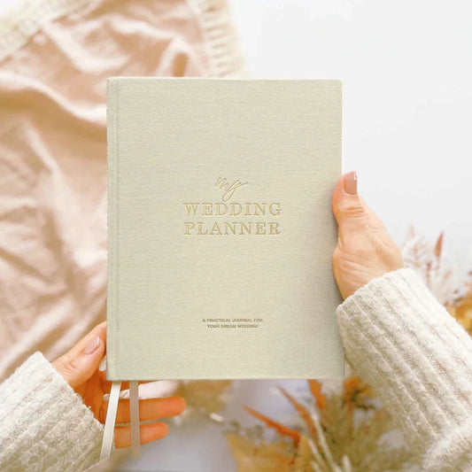 Ivory Cloth Wedding Planner Book with Gold Foil and 18-Month Calendar.