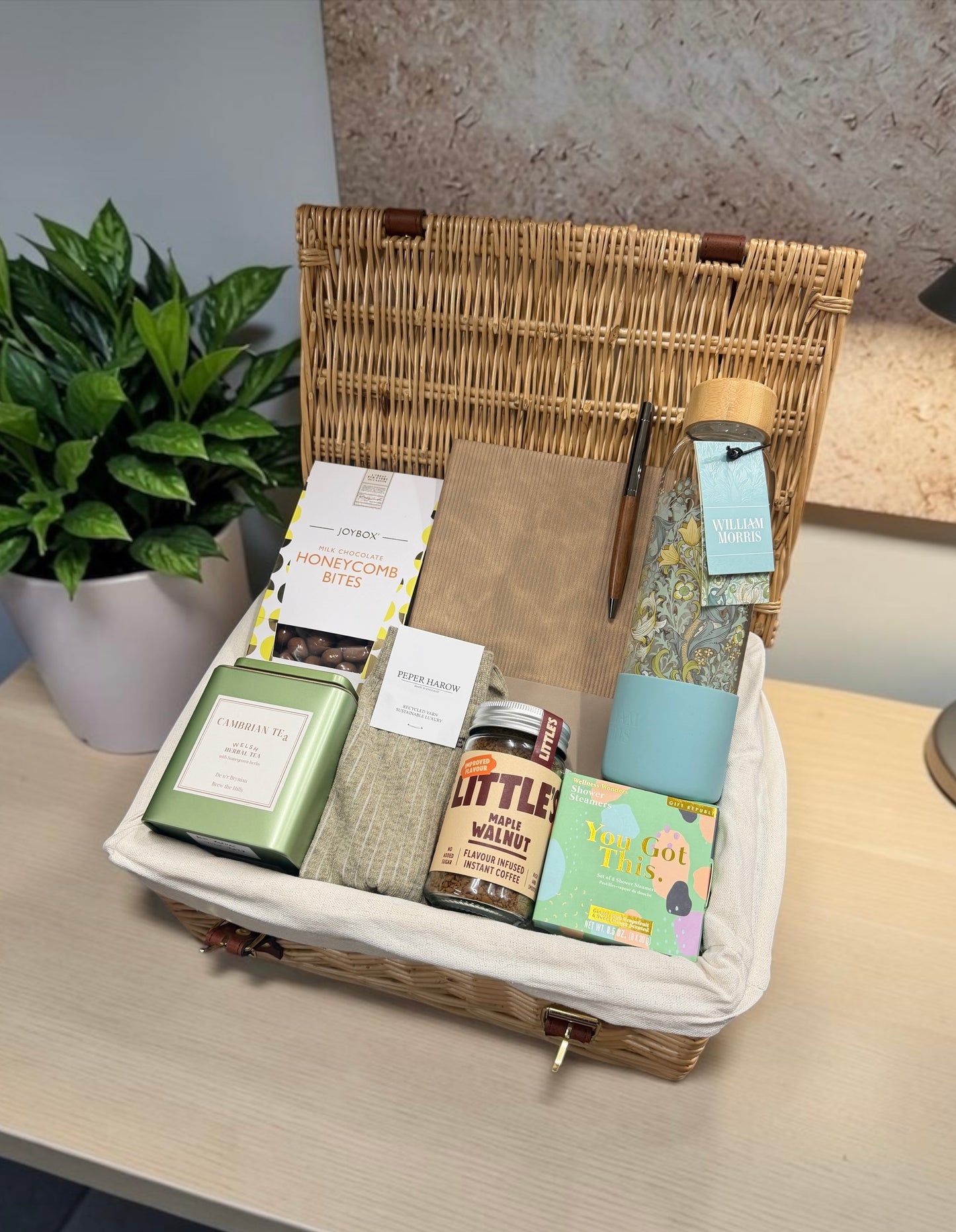 A gift hamper for a new job for her, including pen that can be personalised, notebook, socks, coffee, tea and more 