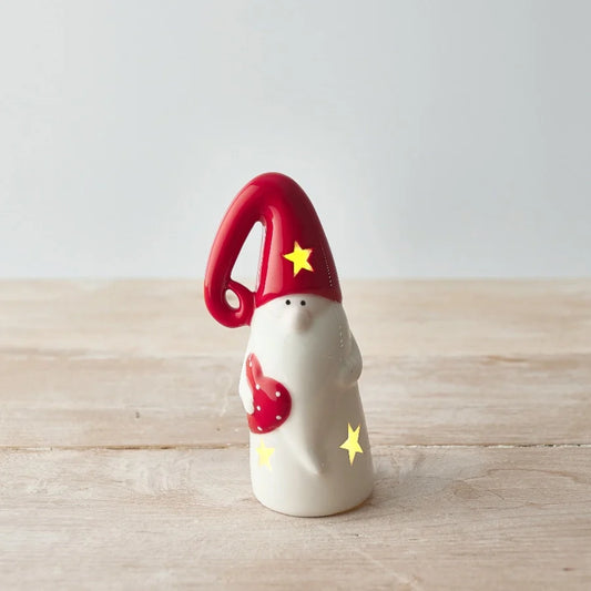 Nordic Gonk T-Light Holder with Red Hat on wooden surface.