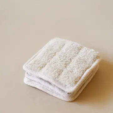 Organic Lifestyle Cotton Terry Square Scrub on beige surface.