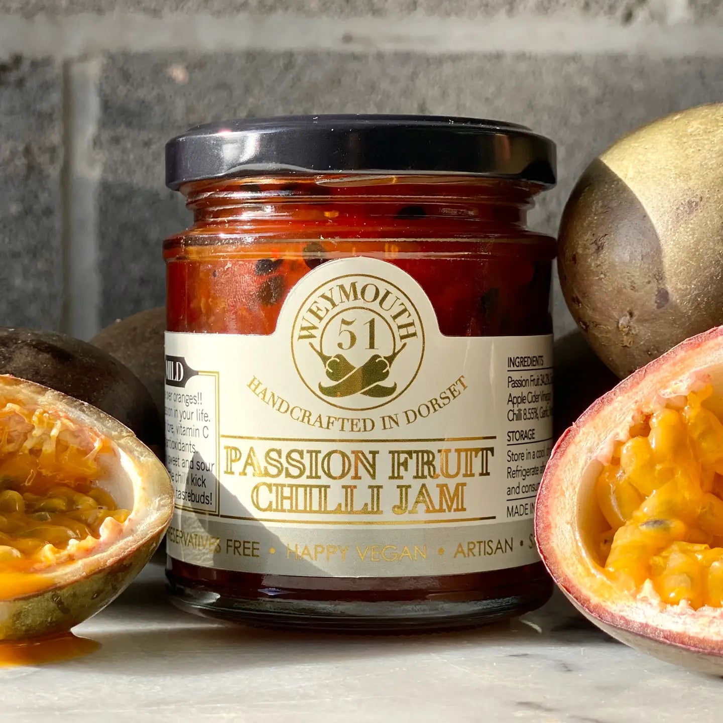 Passion Fruit Vegan Mild Chilli Jam 190ml jar with fresh passion fruit, perfect for cheese and savory dishes.