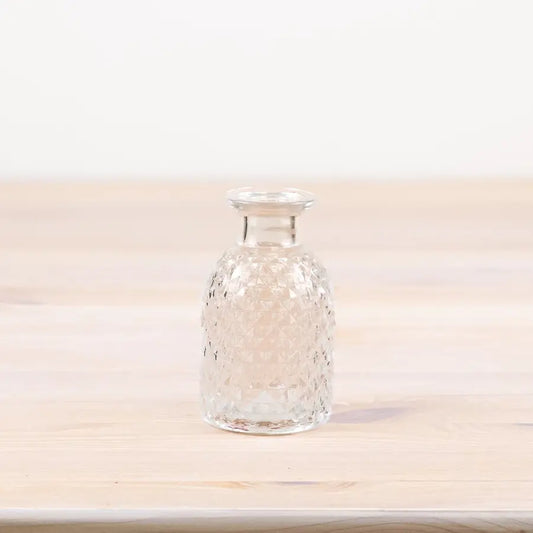 Patterned glass flower vase, 9.2cm tall, clear design.