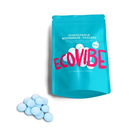 Peppermint Mouthwash tablets in biodegradable pouch with scattered tablets.