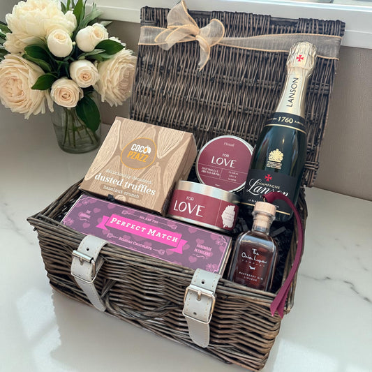 Mark the moment with champagne, truffles, chocolates, a candle, and raspberry liqueur.