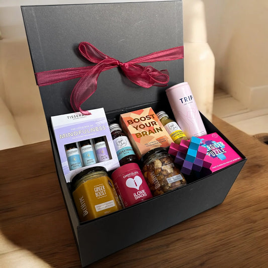 Brain Boosting Gift Box with Tisserand oils, energiser puzzle, ginger chocolate, boost cards, cranberry shots, TRIP drink, honey nuts.