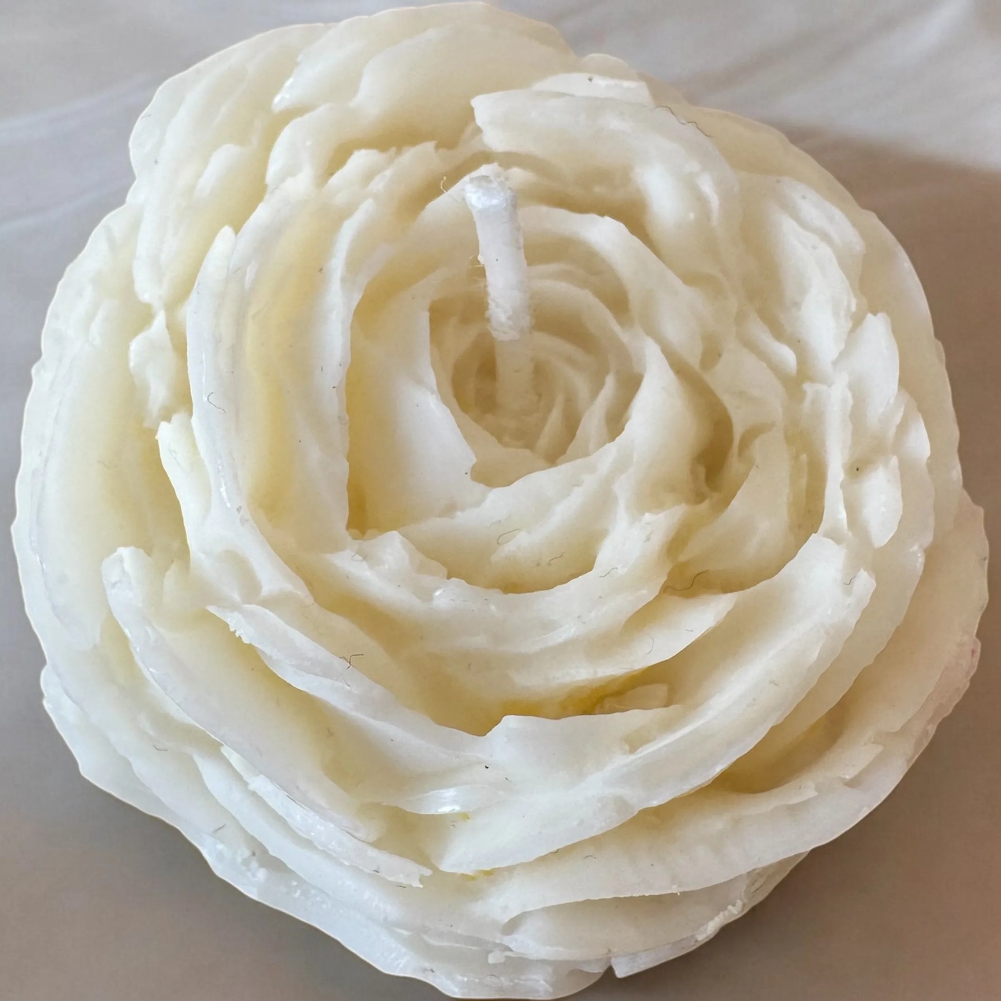 Peony White Mini Candle shaped like a blooming flower.