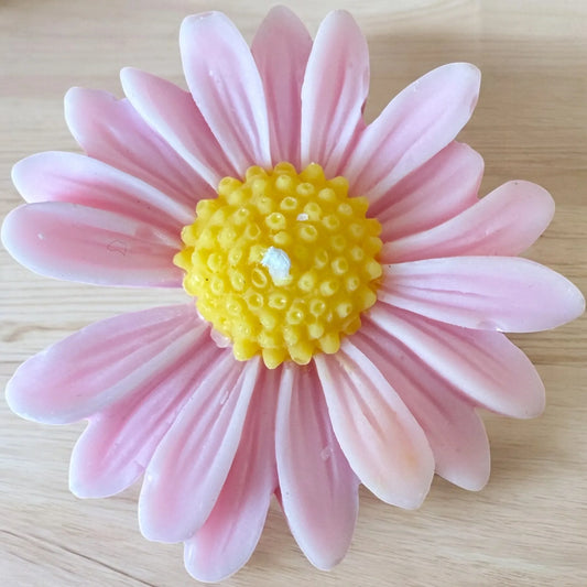 Pink Daisy Mini Candle shaped like a pink flower with yellow center.