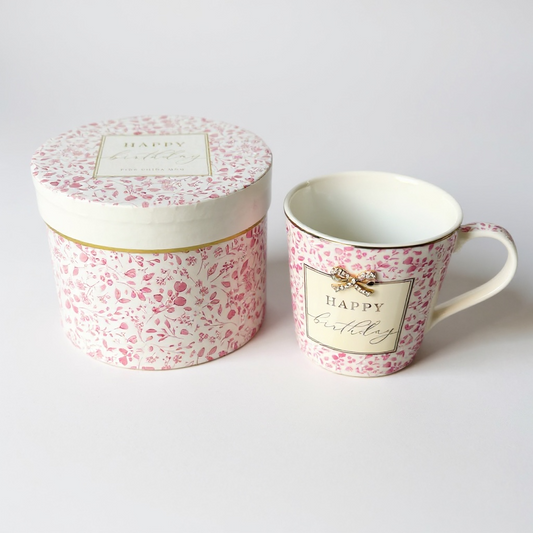 Floral-patterned mug and matching gift box on a light gray background