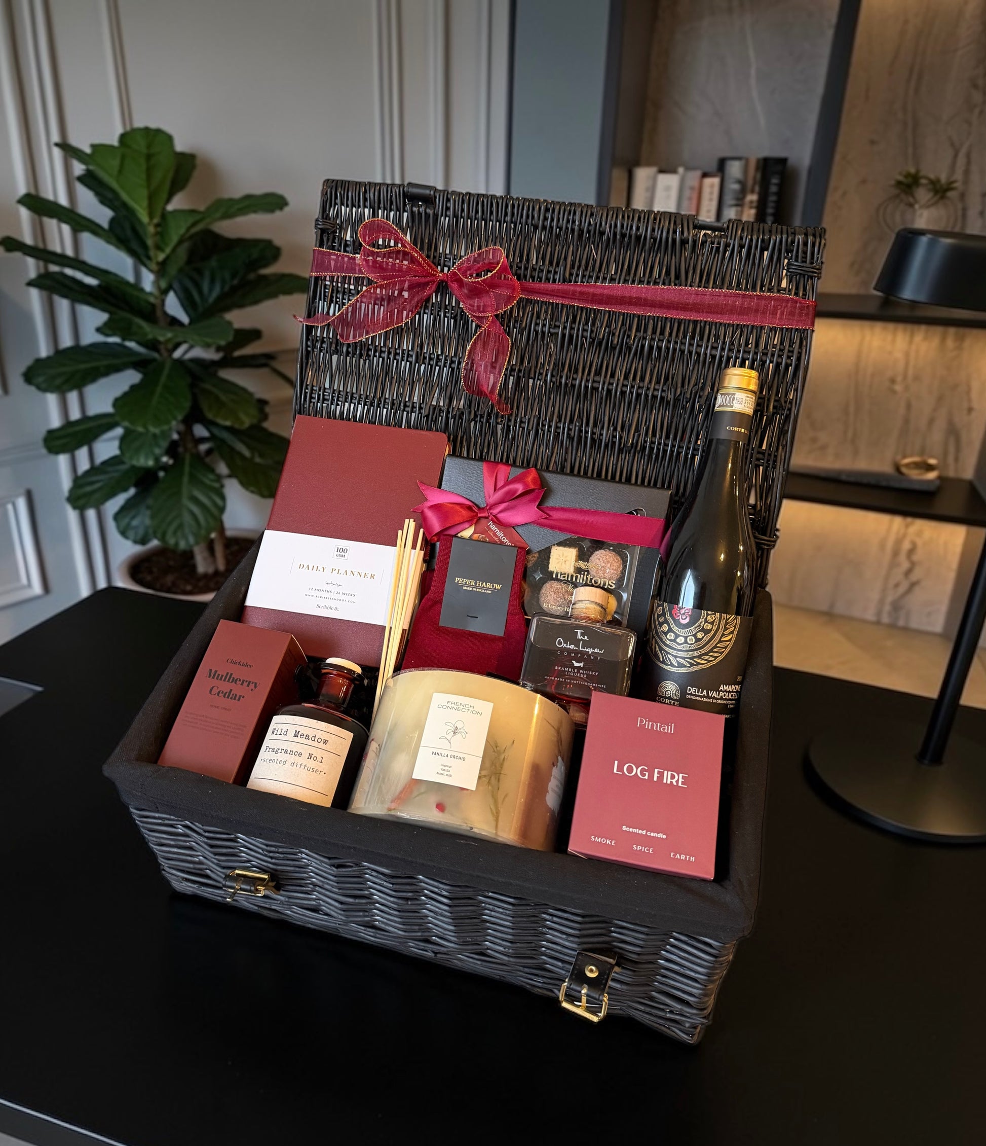 Luxury gift hamper with productivity planner, candles, reed diffuser, chocolates, whiskey and choice of fine wine or Champagne.