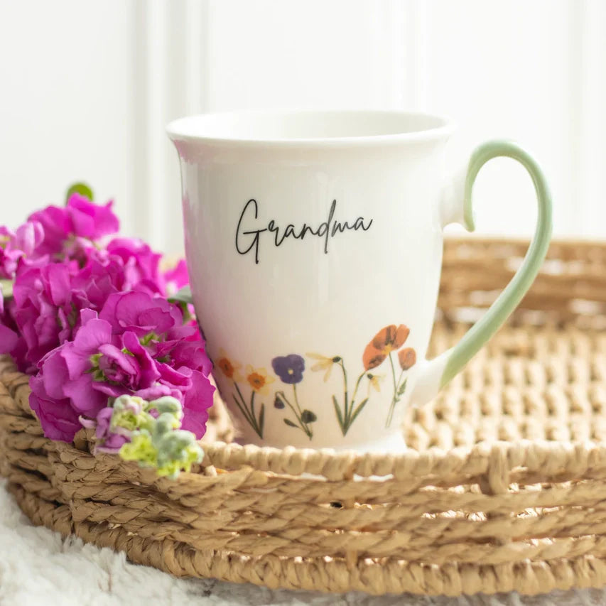 Wildflower decorated mug for grandma with daisies, violets, snowdrops, and poppies design.