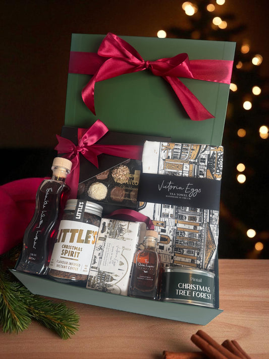 British Christmas Gift Set with Bramble Whisky Oxton Liqueur, festive bauble, Hamiltons chocolates, London tea towel, hand soap, Christmas candle, and coffee.