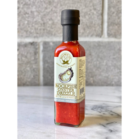 Rockfish Oyster Drizzle Fermented Vegan Chilli Sauce 220ml bottle on marble surface.