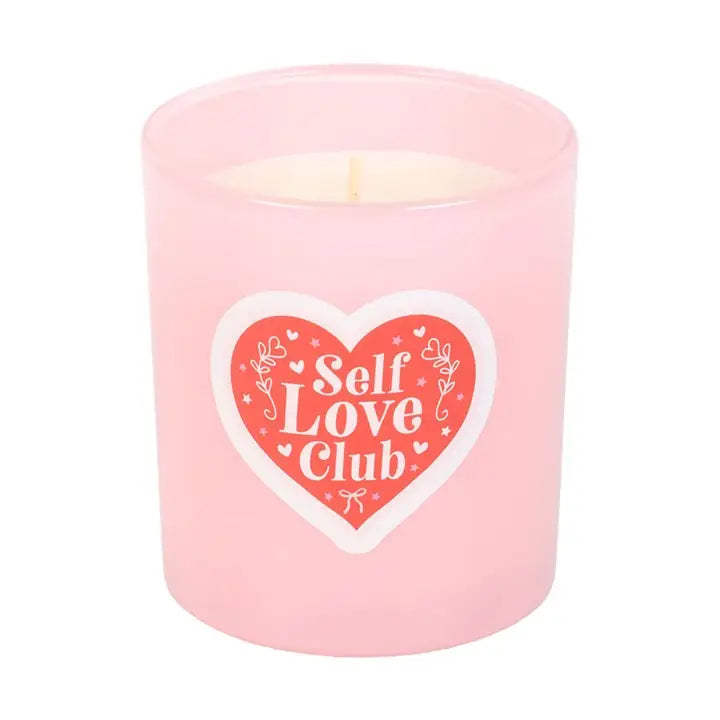 Pink candle with a heart-shaped 'Self Love Club' label.