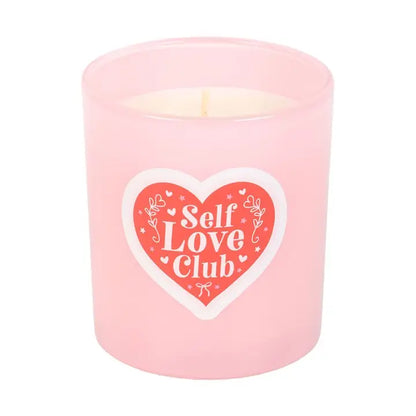 Pink candle with a heart-shaped 'Self Love Club' label.