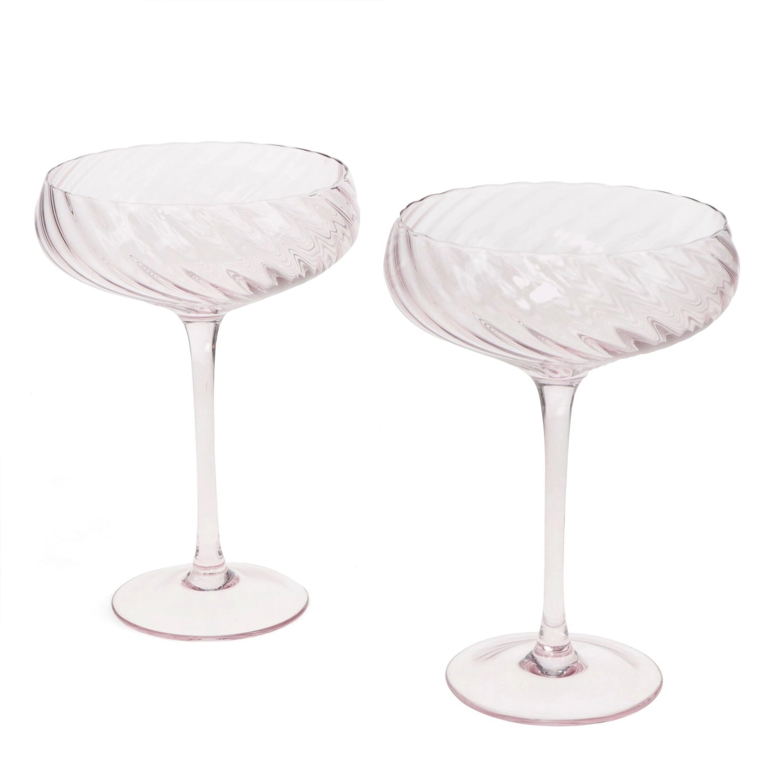 Set of two pale pink scalloped coupe cocktail glasses with elegant textured bowls.