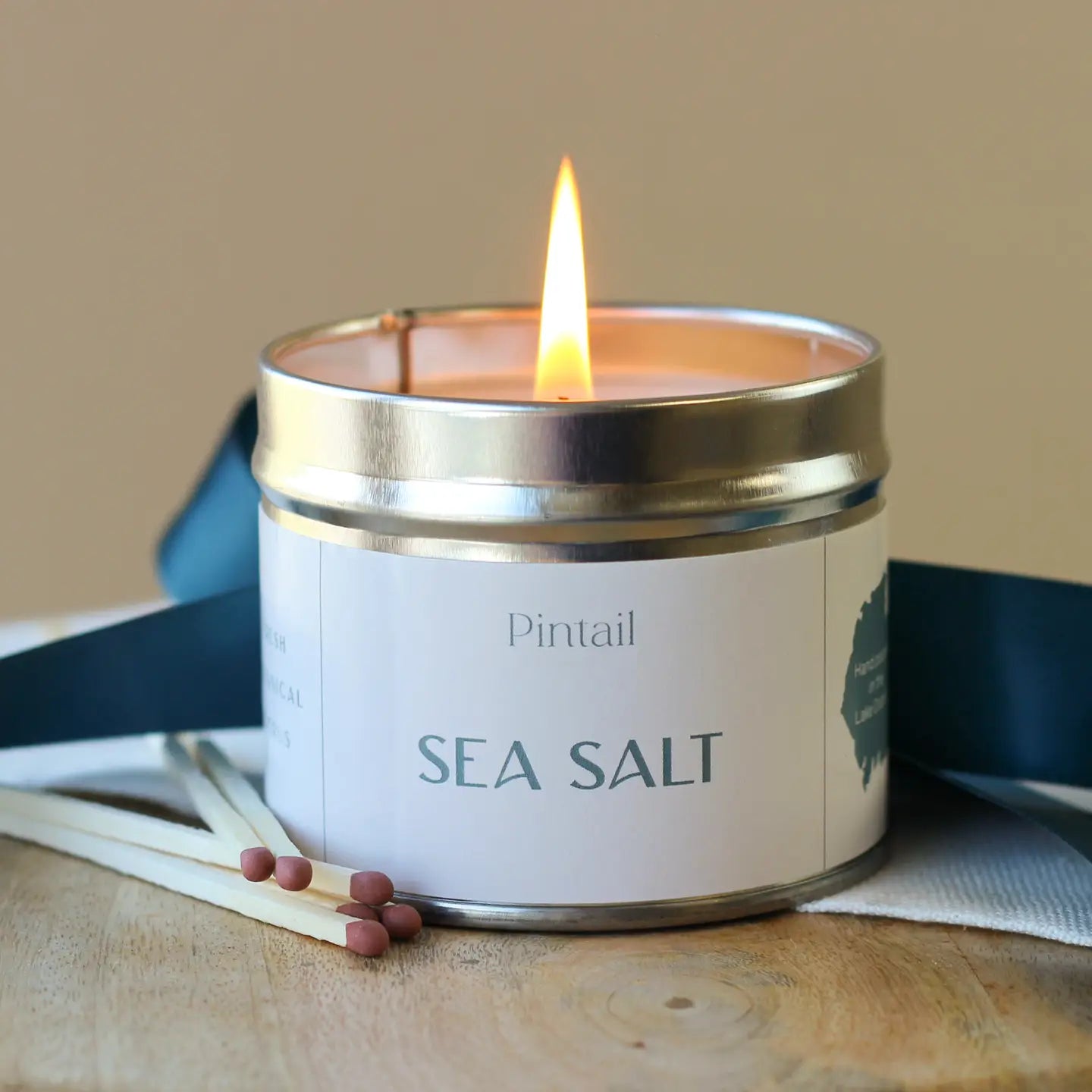 Sea Salt classic tin candle with citrus, amber, and sea kale scent.