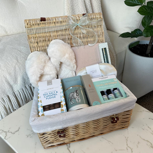 Self care luxury hamper for her with planner, eye mask, aromatherapy kit, bath salts, slippers, mug and sweet treats.