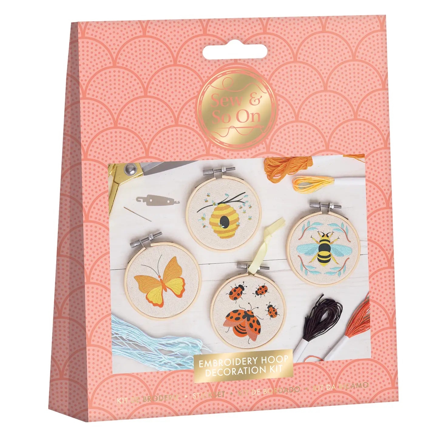 Bees & Bugs embroidery craft kit with fabric pieces, threads, bamboo hoops, and tools arranged together.