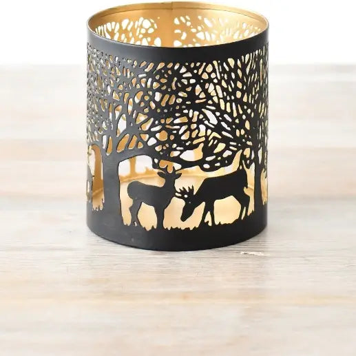 Small reindeer cut out votive candle holder with intricate gold design.