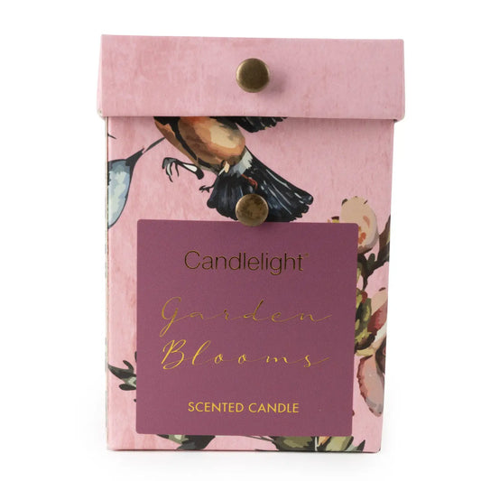 Small ridged glass candle in Garden Blooms Plum, featuring a floral fragrance in a textured glass container.