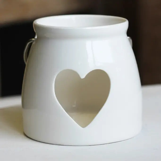White ceramic lantern with a heart-shaped cutout 