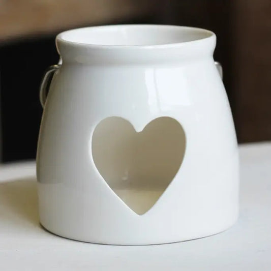 White ceramic lantern with a heart-shaped cutout 