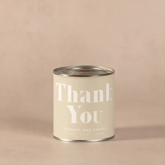 Thank You Conscious Candle in beige tin container.