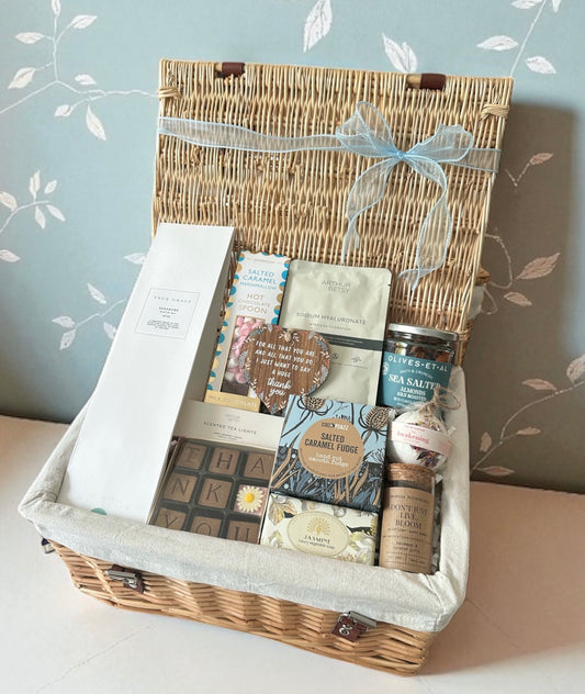 Thank you gift set with True Grace diffuser, self-care treats, fudge, hot chocolate, and thank-you chocolates – perfect for pampering.