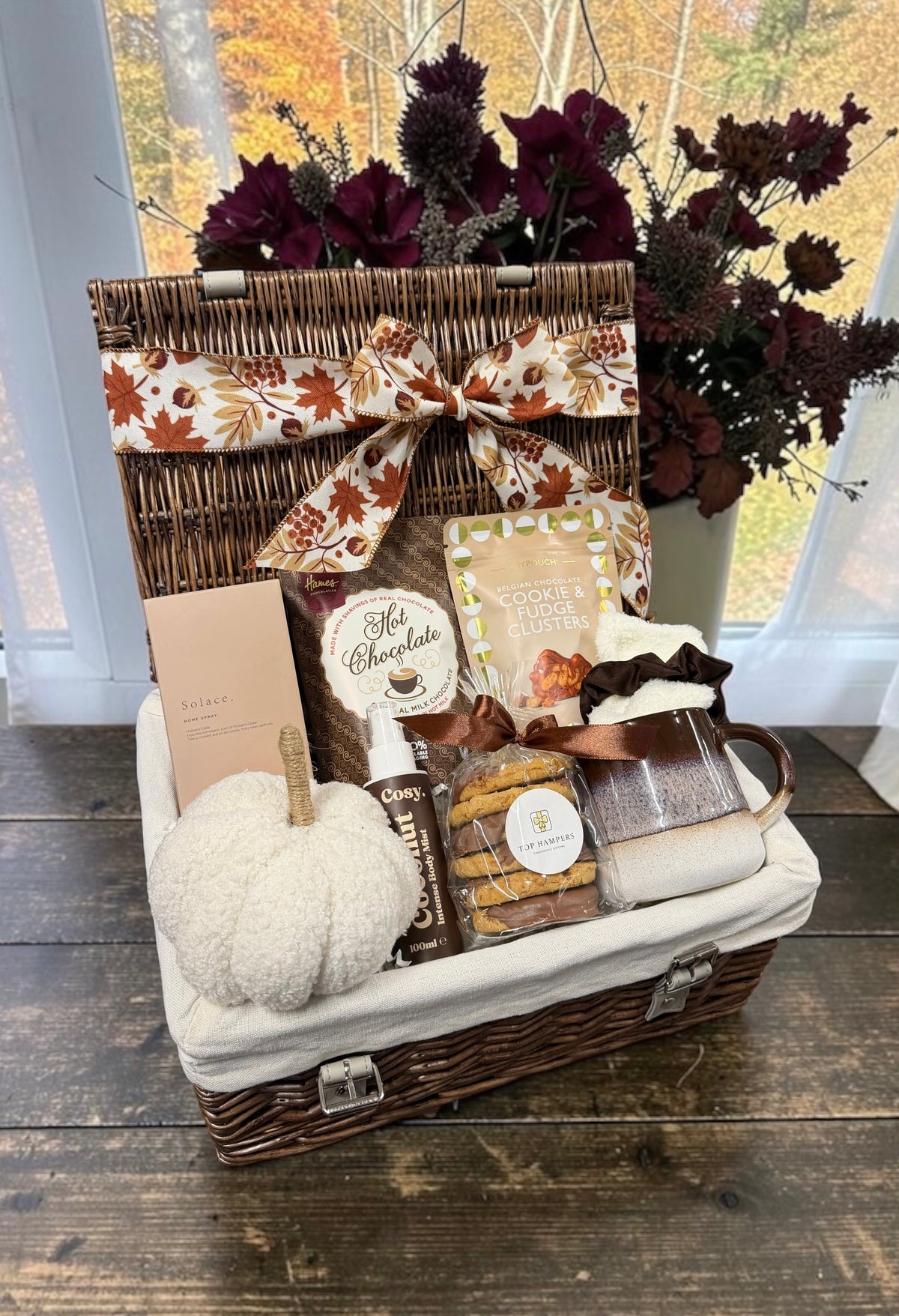 The Autumn Comforts Hamper with a home spray, hot chocolate, a reactive glaze mug and chocolate treats. A cosy gift for the start of autumn.
