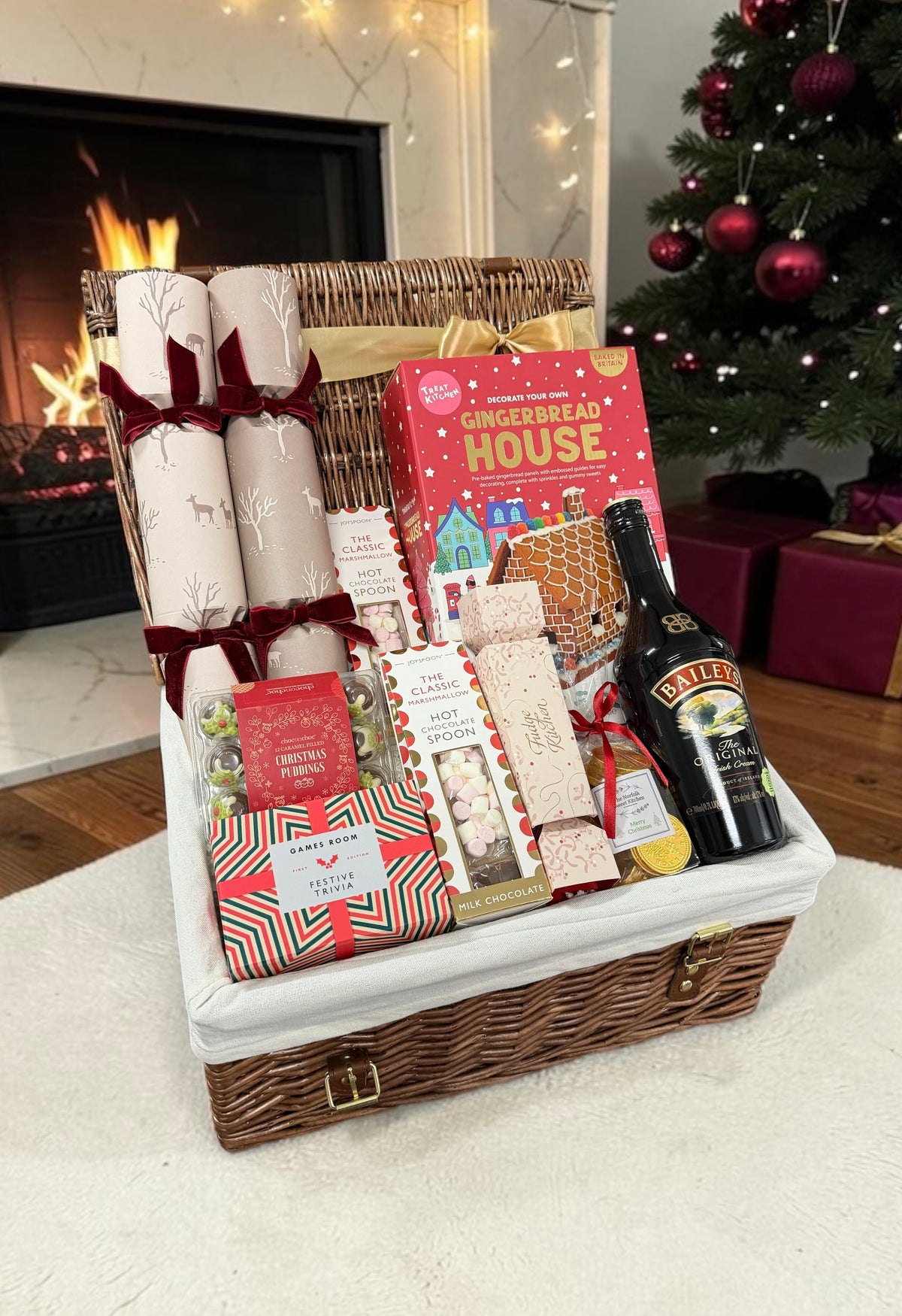 The Festive Family Sharing Hamper brings crackers, festive trivia, a gingerbread house kit, chocolates, fudge and Baileys or red wine.