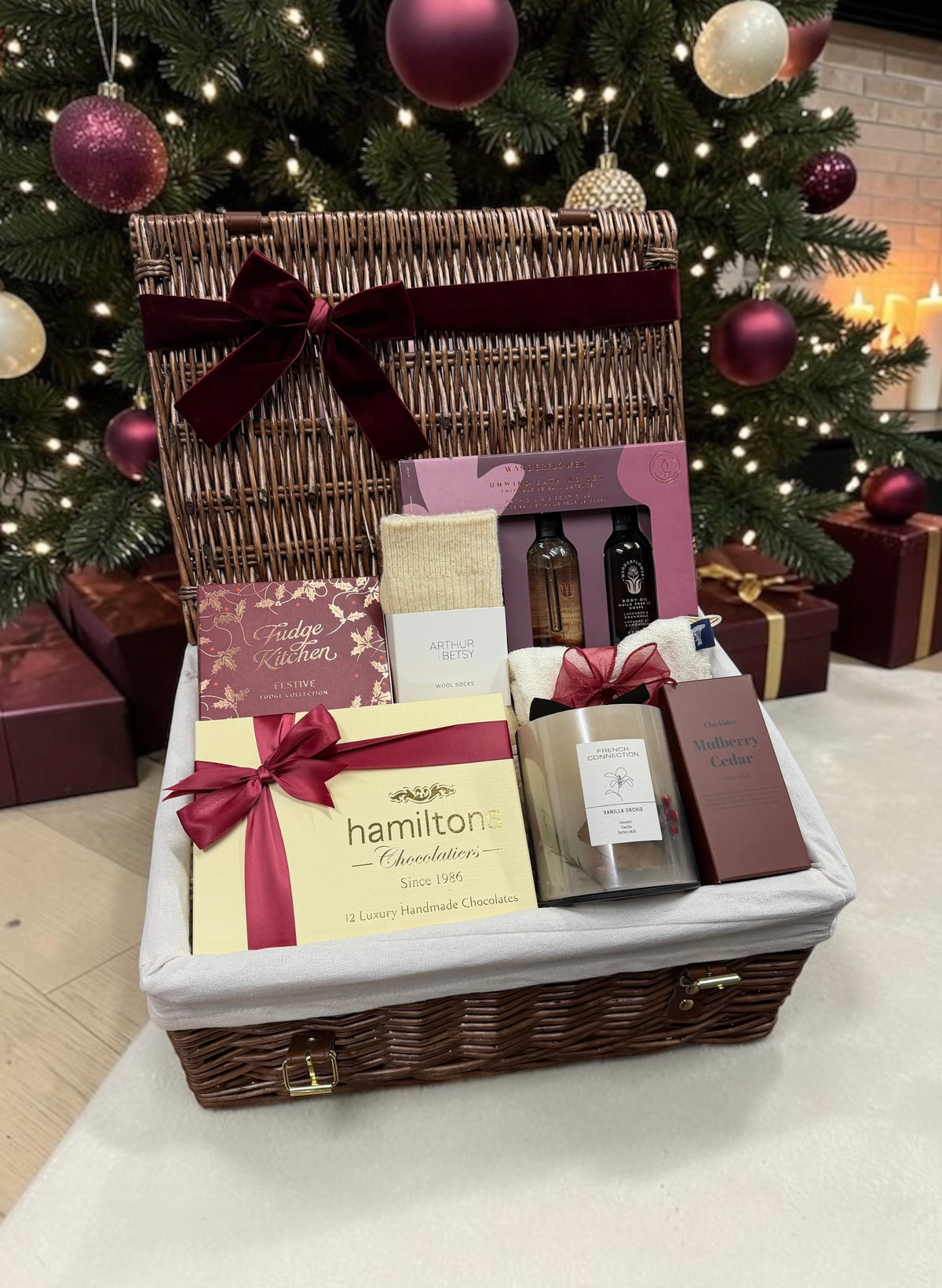The Festive Pamper Hamper brings luxury chocolates, festive fudge, a bathing set, wool socks, a French Connection Vanilla Orchid candle and home spray.