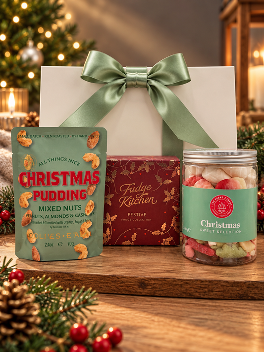 The Festive Treats Gift Bag brings Fudge Kitchen festive fudge, Christmas pudding spiced nuts and a jar of Christmas sweets to share in a gift bag. 