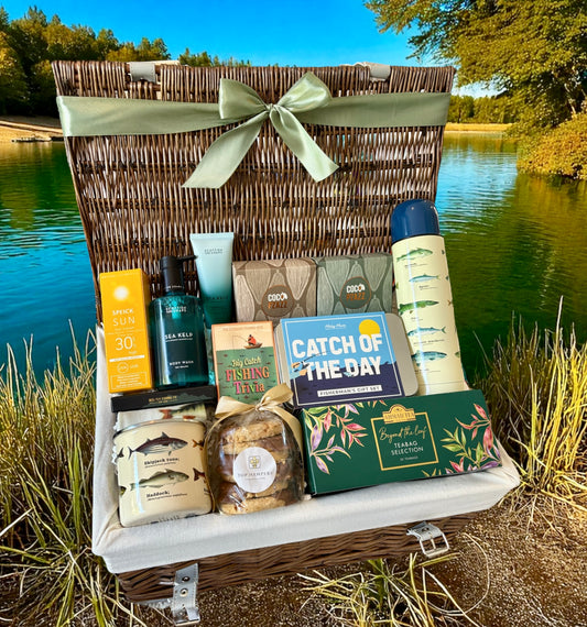 The Fisherman’s Gift Hamper with fishing-themed gifts, body care, flask, chocolate, tea, biscuits, and trivia game.