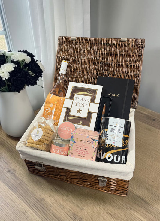 The Heartfelt Thanks Hamper brings rosé or Prosecco, truffles, a Thank You chocolate bar, candle, notebook and pen, crisps and butter oaties.