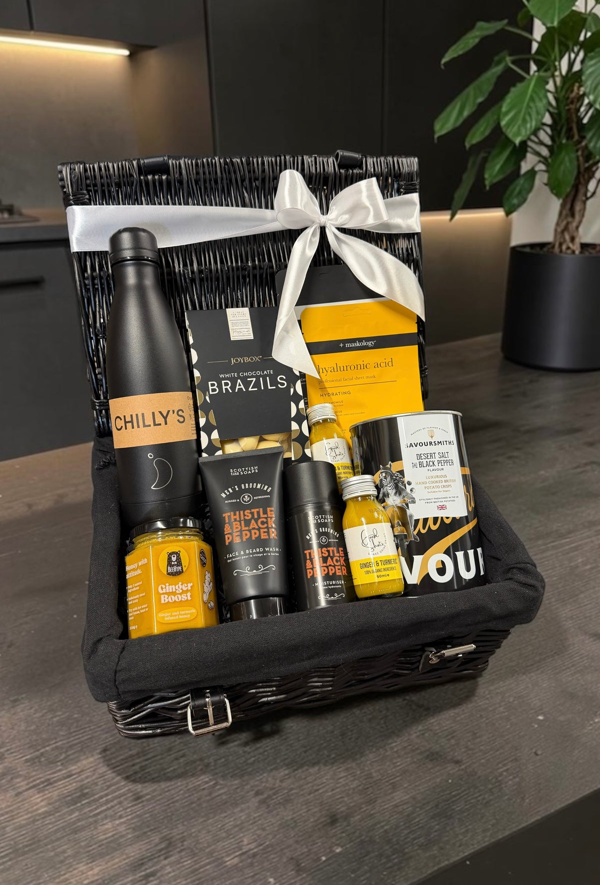 The Men's Care Package with a water bottle, grooming essentials, a face mask, ginger shots and treats. A wellness gift for any occasion.
