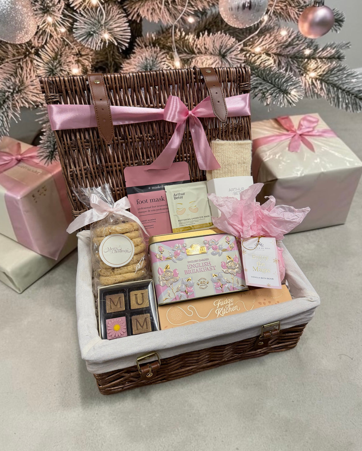 The Merry Christmas Mum Hamper brings MUM chocolates, fudge, English Breakfast tea, oaties, a bath bomb, wool socks and pampering masks.