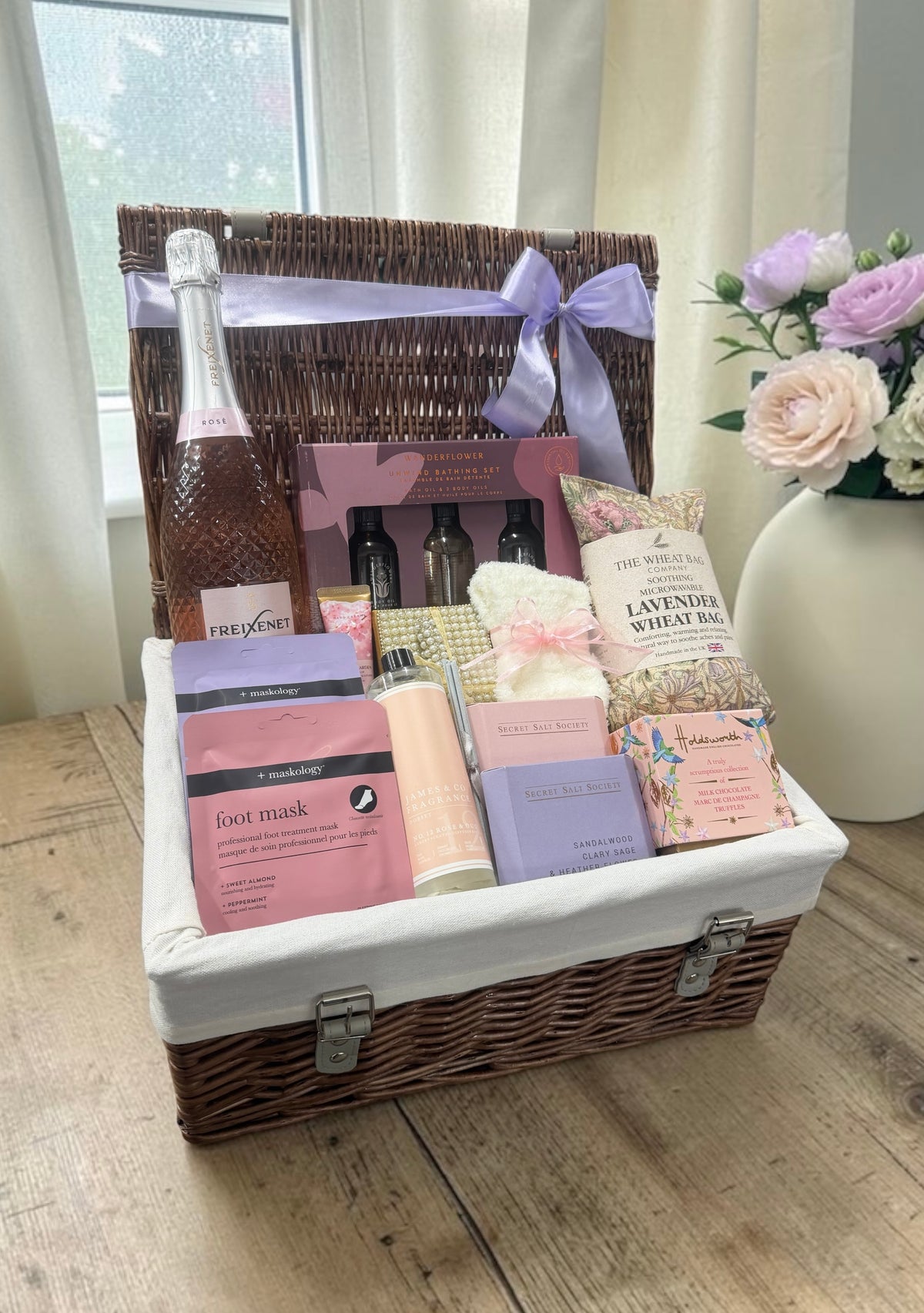The Top to Toe Indulgence Hamper brings bath and body oils, masks, a wheat bag, fluffy socks, a diffuser, truffles and a choice of fizz.