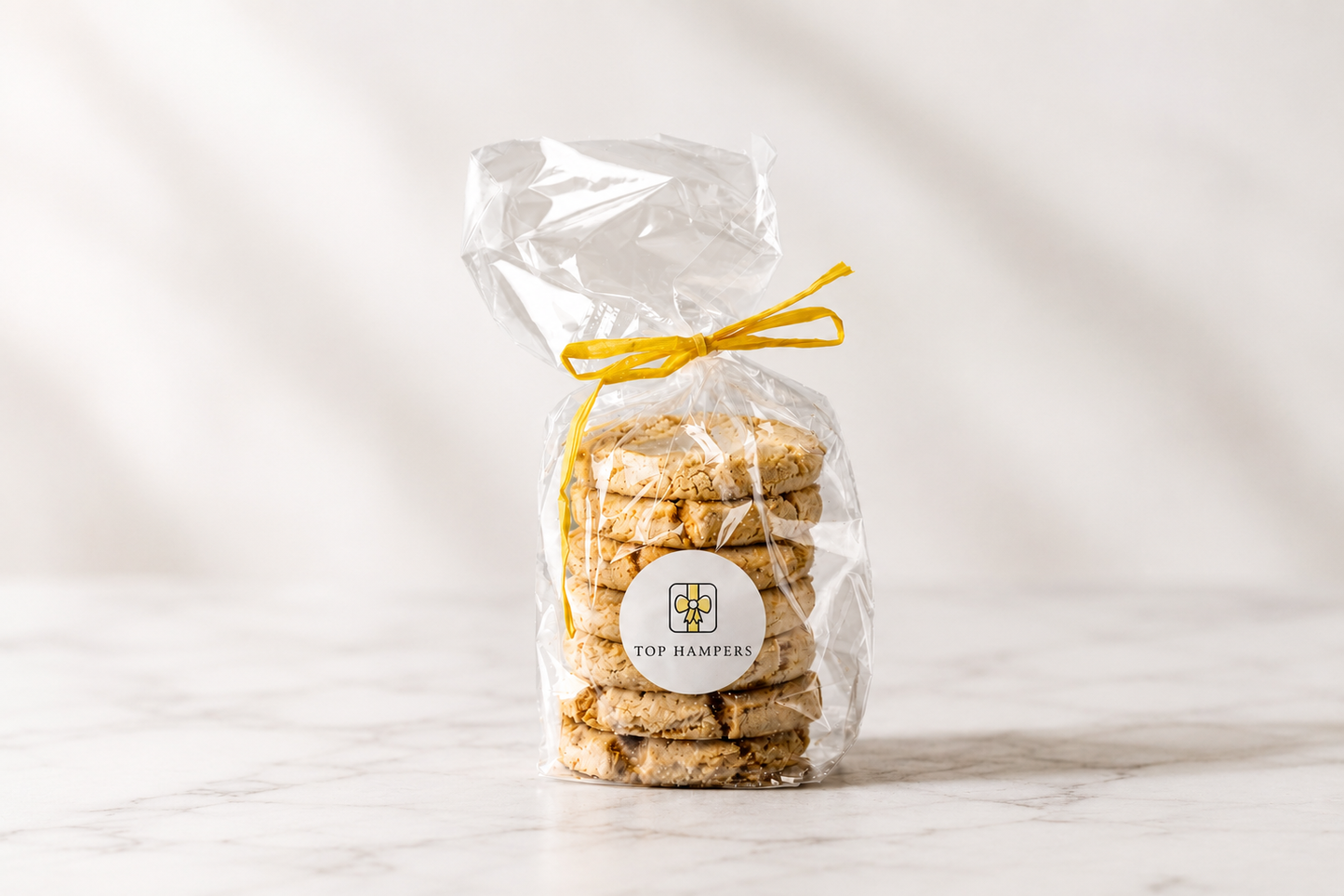 Gift bag of artisan all butter oaties tied with a yellow ribbon and finished with a Top Hampers sticker