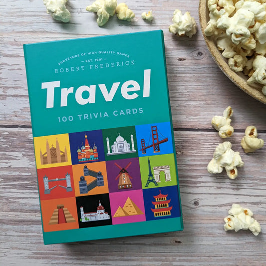 Travel Trivia Cards box on a wooden surface with popcorn.