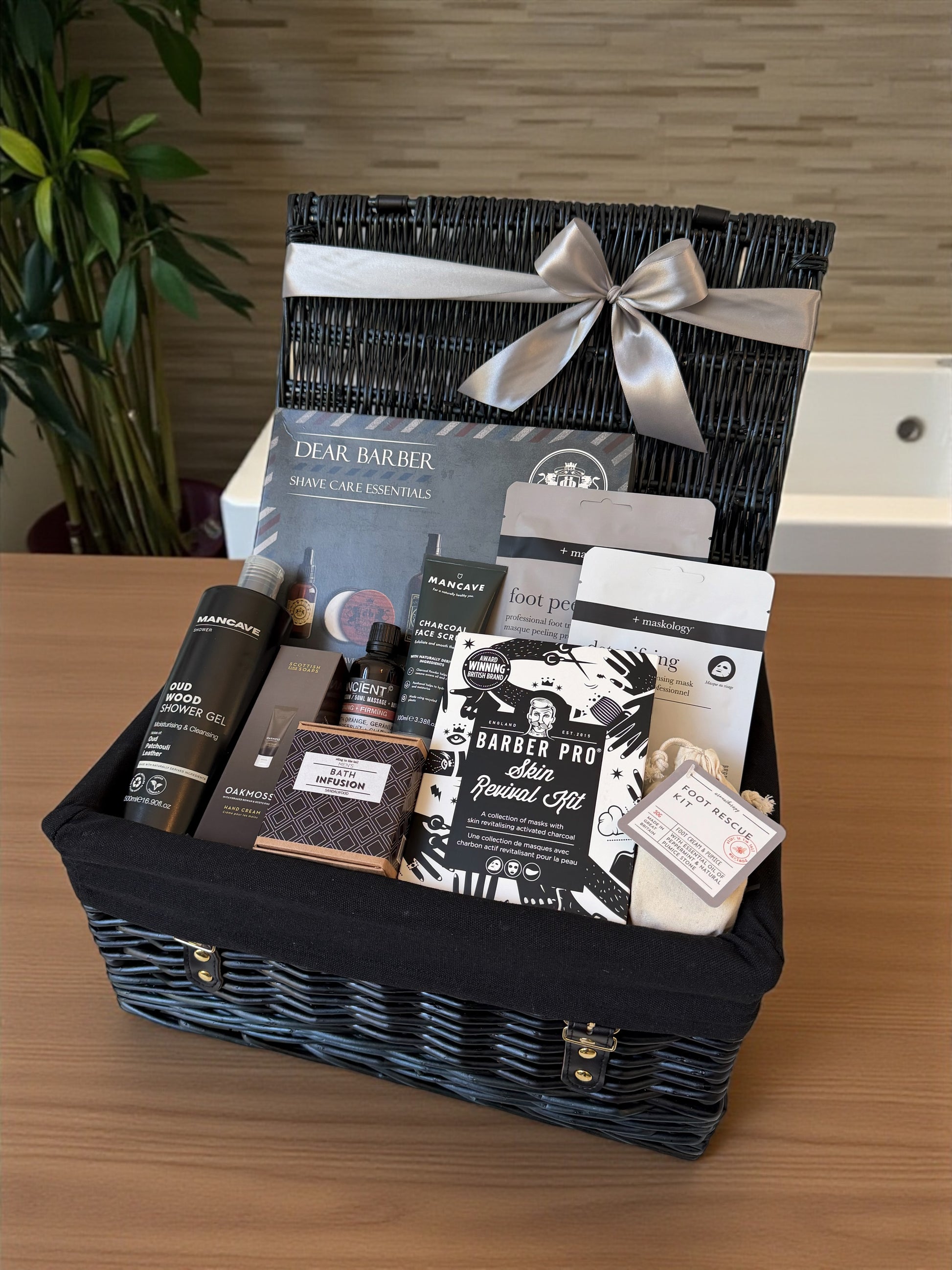 Gift basket with men’s grooming products on a wooden surface