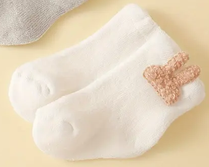 Baby Bunny Socks in white with bunny ears, newborn size.