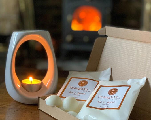 Vegan wax melts bronze with oud and jasmine scent displayed with wax warmer.